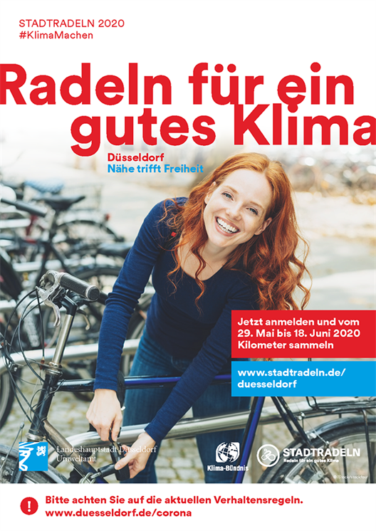 oster of the action Stadtradeln of the city of Düsseldorf. You see a woman standing at her bicycle.