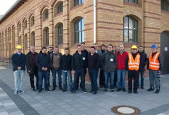 This picture shows the team of Campus IT in front of the building namend "Großviehhalle".