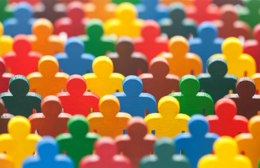 A colorful crowd of wooden men who stand as a sign of diversity