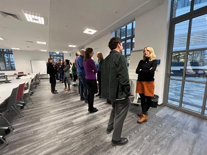 People stand in pairs facing each other and talk