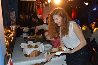 International students are getting food at a big buffet.